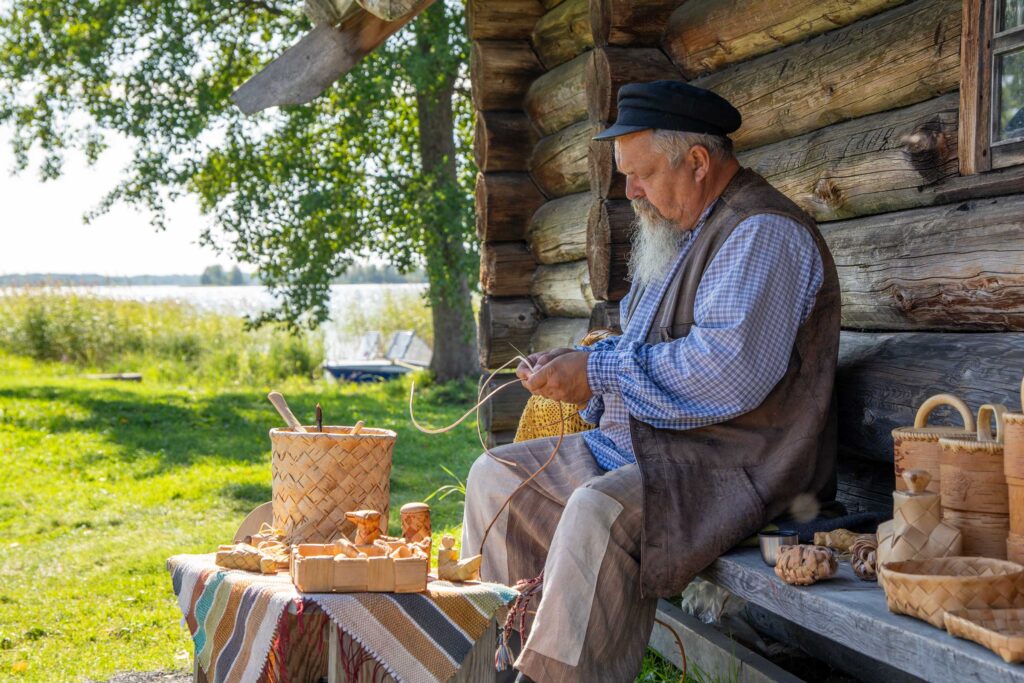 Ремесленник плетет корзины на Кижи